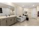 Bright bathroom with a soaking tub, walk in shower, dual sink vanity, and tile floors at 230 Cactus Sunrise St, Las Vegas, NV 89138