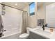 Well-lit bathroom featuring a modern vanity with matte black fixtures and a shower-tub with tiled walls at 230 Cactus Sunrise St, Las Vegas, NV 89138