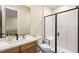Well-lit bathroom featuring a sleek vanity and a modern walk-in shower with glass door at 230 Cactus Sunrise St, Las Vegas, NV 89138