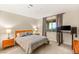 Cozy bedroom with a comfortable queen-sized bed, wooden nightstands, and a workstation setup near a bright window at 230 Cactus Sunrise St, Las Vegas, NV 89138