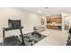 Large bonus room with kitchenette, sofa and workout equipment at 230 Cactus Sunrise St, Las Vegas, NV 89138