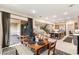 Open-concept dining area leading to a patio, island kitchen, and staircase at 230 Cactus Sunrise St, Las Vegas, NV 89138