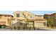Inviting two-story home featuring neutral stucco, tiled roof, manicured landscaping, and a convenient two-car garage at 230 Cactus Sunrise St, Las Vegas, NV 89138