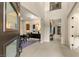 Bright and airy foyer featuring tile flooring, soaring ceilings, and an open floor plan at 230 Cactus Sunrise St, Las Vegas, NV 89138