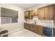 This kitchenette features wood cabinets, sleek countertops, and a beverage cooler at 230 Cactus Sunrise St, Las Vegas, NV 89138
