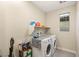 Functional laundry room featuring a stacked washer and dryer and shelf storage at 230 Cactus Sunrise St, Las Vegas, NV 89138