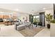 Spacious living room open to kitchen with comfortable seating and access to the outdoors at 230 Cactus Sunrise St, Las Vegas, NV 89138