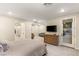 Bright main bedroom with en-suite bathroom, large TV, and a comfortable sitting area at 230 Cactus Sunrise St, Las Vegas, NV 89138