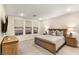 Cozy main bedroom with a large bed, neutral decor, and three windows bringing natural light at 230 Cactus Sunrise St, Las Vegas, NV 89138