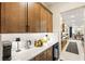 Butler's pantry with white countertops and modern appliances leading to the kitchen at 230 Cactus Sunrise St, Las Vegas, NV 89138
