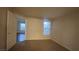 A bright bedroom features neutral walls, carpet floors, a window, and a doorway leading to another room at 2300 E Silverado Ranch Blvd # 1104, Las Vegas, NV 89183