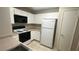 Well-lit kitchen includes white cabinets and appliances at 2300 E Silverado Ranch Blvd # 1104, Las Vegas, NV 89183