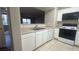 Functional kitchen features white cabinetry and views to the balcony at 2300 E Silverado Ranch Blvd # 1104, Las Vegas, NV 89183
