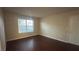 A bright living room with dark wood-look flooring, window and door at 2300 E Silverado Ranch Blvd # 1104, Las Vegas, NV 89183