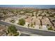 Panoramic aerial view of a residential street featuring houses with desert landscaping, and wide roadways at 2486 Divine Sky Dr, Henderson, NV 89044