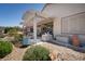 A cozy covered patio area with garden view offers the perfect spot for outdoor enjoyment at 2486 Divine Sky Dr, Henderson, NV 89044