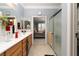 Bright bathroom with double vanity, tile floor, and shower at 2486 Divine Sky Dr, Henderson, NV 89044