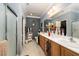 Well-lit bathroom with double sinks, shower, and tile flooring at 2486 Divine Sky Dr, Henderson, NV 89044