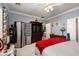 Comfortable bedroom features ceiling fan, room divider, and television cabinet at 2486 Divine Sky Dr, Henderson, NV 89044