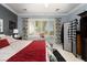 Inviting bedroom with large window, neutral colors, and a cozy red blanket at 2486 Divine Sky Dr, Henderson, NV 89044