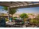 Relaxing covered patio with comfortable seating and scenic mountain backdrop at 2486 Divine Sky Dr, Henderson, NV 89044