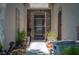 View of the home's gated entryway with potted plants flanking the walkway at 2486 Divine Sky Dr, Henderson, NV 89044
