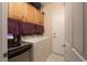 Laundry area with washer, dryer, cabinets, and access to the outdoors at 2486 Divine Sky Dr, Henderson, NV 89044