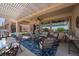 Spacious covered patio featuring stylish outdoor furniture and a bright blue rug for entertaining at 2486 Divine Sky Dr, Henderson, NV 89044
