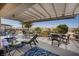 Outdoor patio with shaded pergola, comfortable seating, and mountain views at 2486 Divine Sky Dr, Henderson, NV 89044