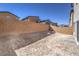 Spacious backyard with fresh dirt, block wall fencing and partial paver patio at 2634 Begonia Falls Ave # 38, North Las Vegas, NV 89081