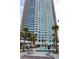 Luxury high-rise building with balconies, pool, palm trees, and outdoor seating at 2700 Las Vegas Blvd # 1804, Las Vegas, NV 89109