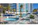Resort-style pool area with palm trees, sun loungers, and stunning city views at 2700 Las Vegas Blvd # 1804, Las Vegas, NV 89109
