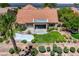 A beautiful aerial view captures a desert home, featuring a tile roof, unique backyard, and lush green landscaping at 2808 Crown Ridge Dr, Las Vegas, NV 89134