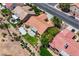 This aerial view showcases a home with a tile roof, backyard patio, and beautiful desert landscaping in a residential neighborhood at 2808 Crown Ridge Dr, Las Vegas, NV 89134
