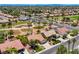 This aerial shot captures a desert home in a golf community with mature trees and landscaping near a golf course at 2808 Crown Ridge Dr, Las Vegas, NV 89134