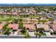 This aerial view of a desert golf course community showcases mature trees, manicured lawns, and nearby mountain views at 2808 Crown Ridge Dr, Las Vegas, NV 89134