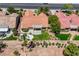 An aerial view shows a home with an orange tile roof and a beautifully landscaped yard, including a mature palm tree at 2808 Crown Ridge Dr, Las Vegas, NV 89134