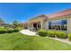 Well-maintained backyard with covered patio, lush lawn, and meticulous landscaping at 2808 Crown Ridge Dr, Las Vegas, NV 89134