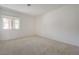 Neutral bedroom features a large window that illuminates the carpeted space at 2808 Crown Ridge Dr, Las Vegas, NV 89134