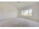 Bright bedroom with a large window view of the well landscaped yard at 2808 Crown Ridge Dr, Las Vegas, NV 89134
