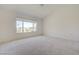 Spacious bedroom with a large window offering views of the outdoors and neutral carpeting at 2808 Crown Ridge Dr, Las Vegas, NV 89134