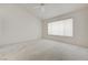 Spacious bedroom with neutral carpet, ceiling fan, and large window at 2808 Crown Ridge Dr, Las Vegas, NV 89134