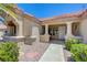 Charming home entrance featuring manicured shrubs, a red tile roof, and a covered entryway at 2808 Crown Ridge Dr, Las Vegas, NV 89134