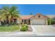 Beautifully landscaped front yard with vibrant green grass and mature palm trees at 2808 Crown Ridge Dr, Las Vegas, NV 89134