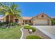 Charming single story home with mature landscaping including a beautiful palm tree in the front yard at 2808 Crown Ridge Dr, Las Vegas, NV 89134