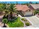 Charming single-story home with a tile roof, a well-manicured lawn, mature palm trees, and an attached two-car garage at 2808 Crown Ridge Dr, Las Vegas, NV 89134