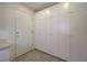 Bright hallway features a wall of white storage cabinets and a white door at 2808 Crown Ridge Dr, Las Vegas, NV 89134