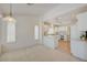 Bright eat-in kitchen boasts white cabinets, tile flooring, and a view to the living area at 2808 Crown Ridge Dr, Las Vegas, NV 89134
