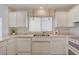 Kitchen sink area features modern appliances, bright lighting, and tile flooring at 2808 Crown Ridge Dr, Las Vegas, NV 89134