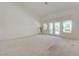 Spacious living room with neutral carpet, vaulted ceilings, and french doors to outdoor area at 2808 Crown Ridge Dr, Las Vegas, NV 89134